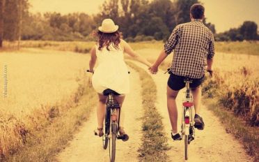 Couple-riding-bike-together